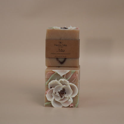 Two bars of soap with floral designs on a beige background