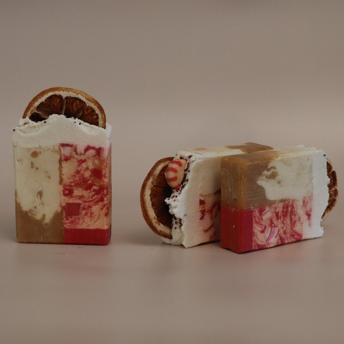 Two soap bars with a marbled design on a beige background