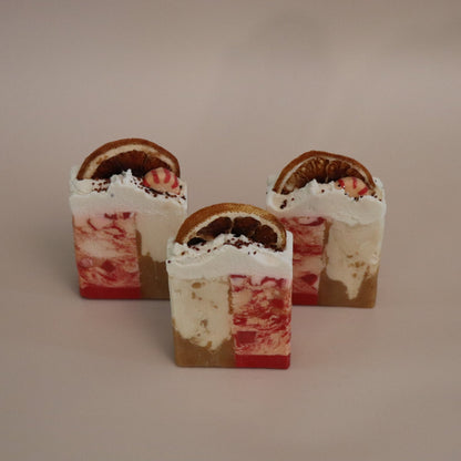Three layered soap bars on a beige background