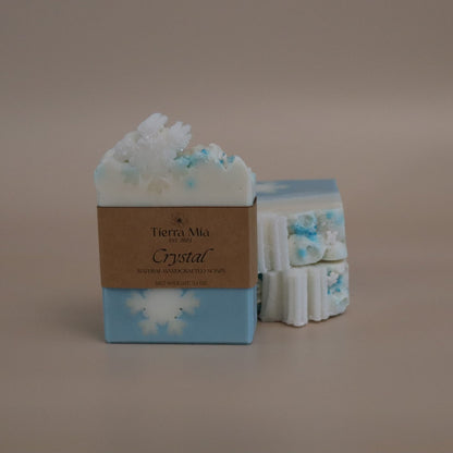 Two bars of soap with decorative packaging on a beige background