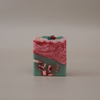 Marbled soap bar with red and green colors on a beige background