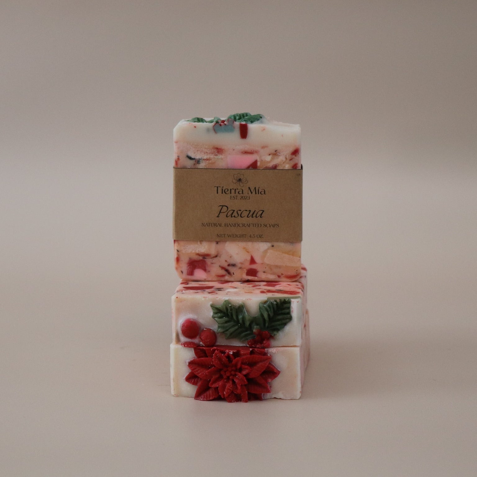Two stacked floral soap bars with a visible brand label on a plain background