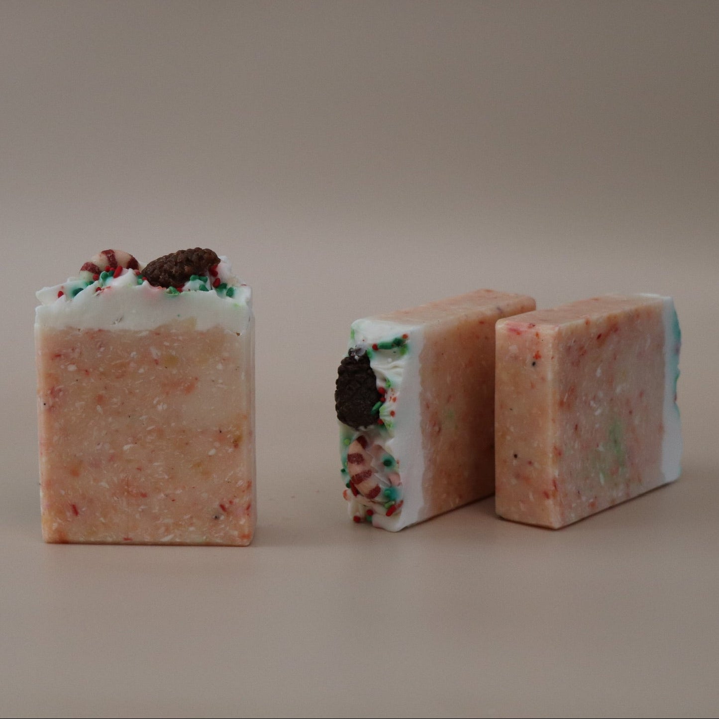 Three colorful soap bars on a beige background