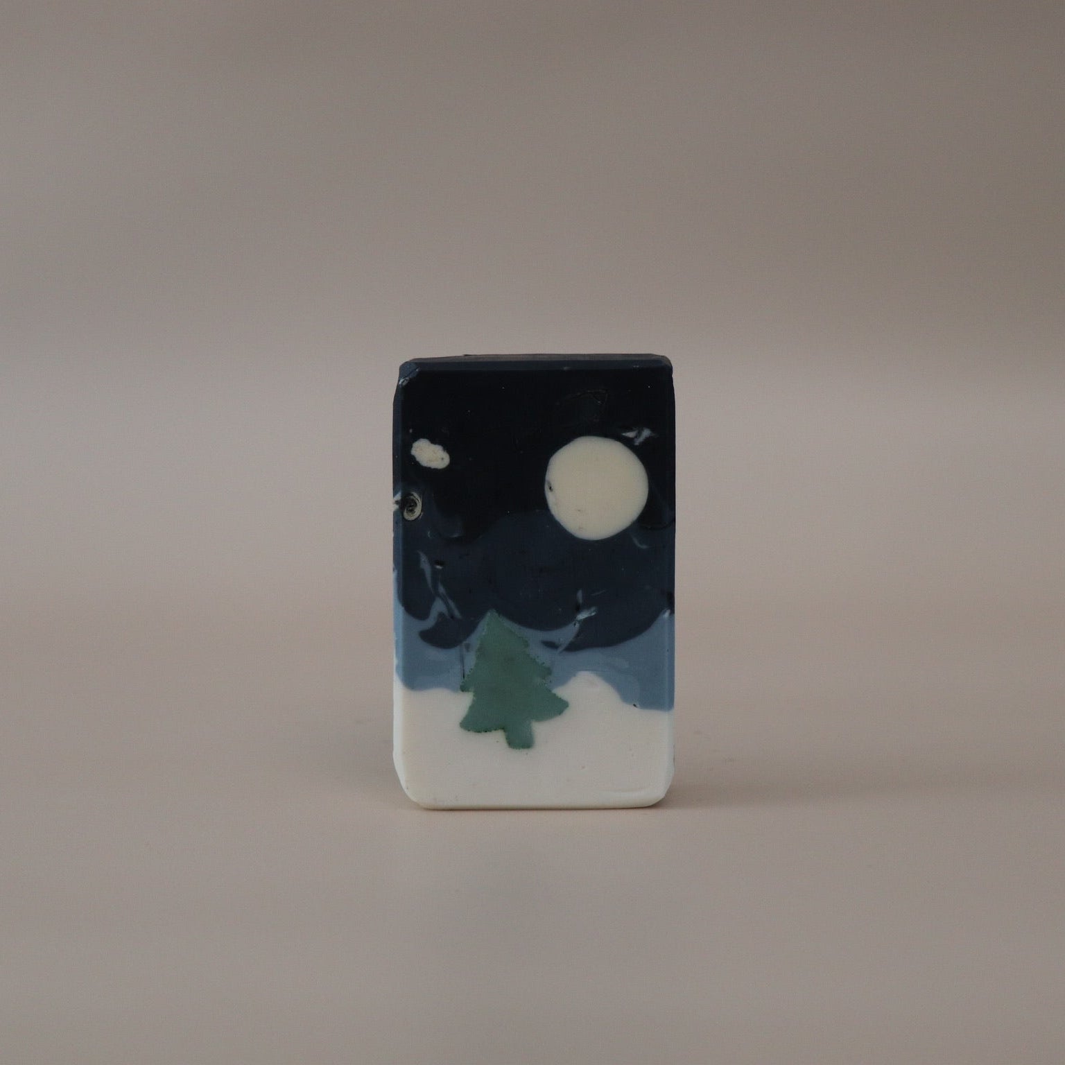 Small rectangular ceramic piece with a night sky design featuring a moon and tree on a beige background