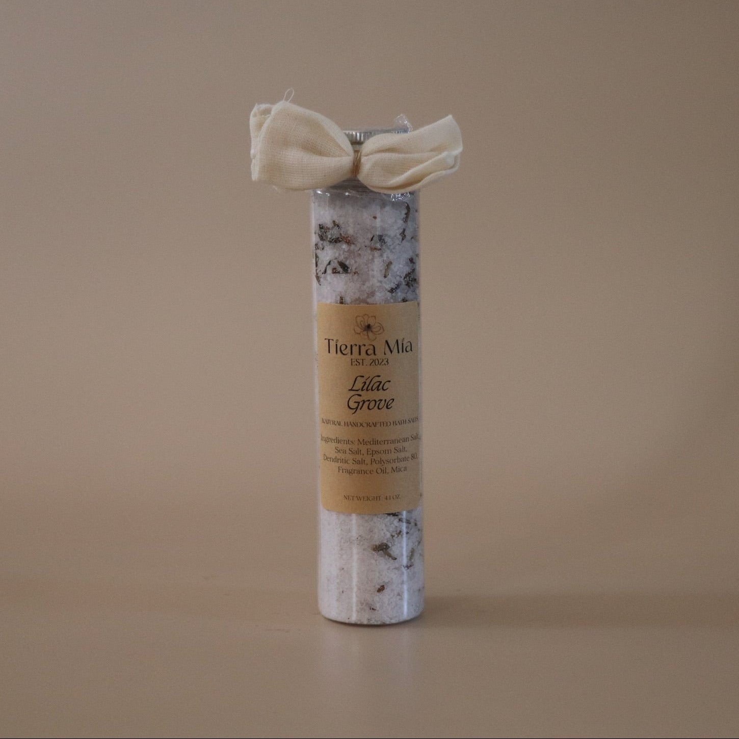 Tube of Bath Salt with a decorative bow on a beige background
