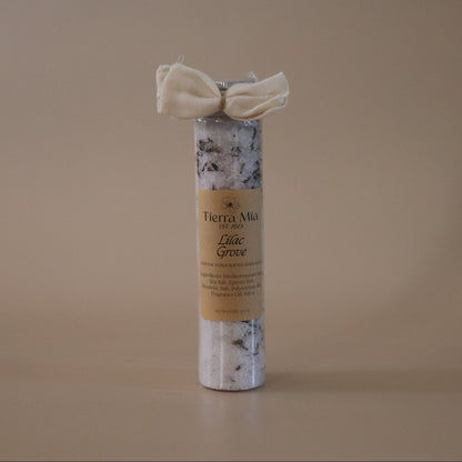 Tube of Bath Salt with a decorative bow on a beige background
