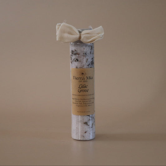Tube of Bath Salt with a decorative bow on a beige background