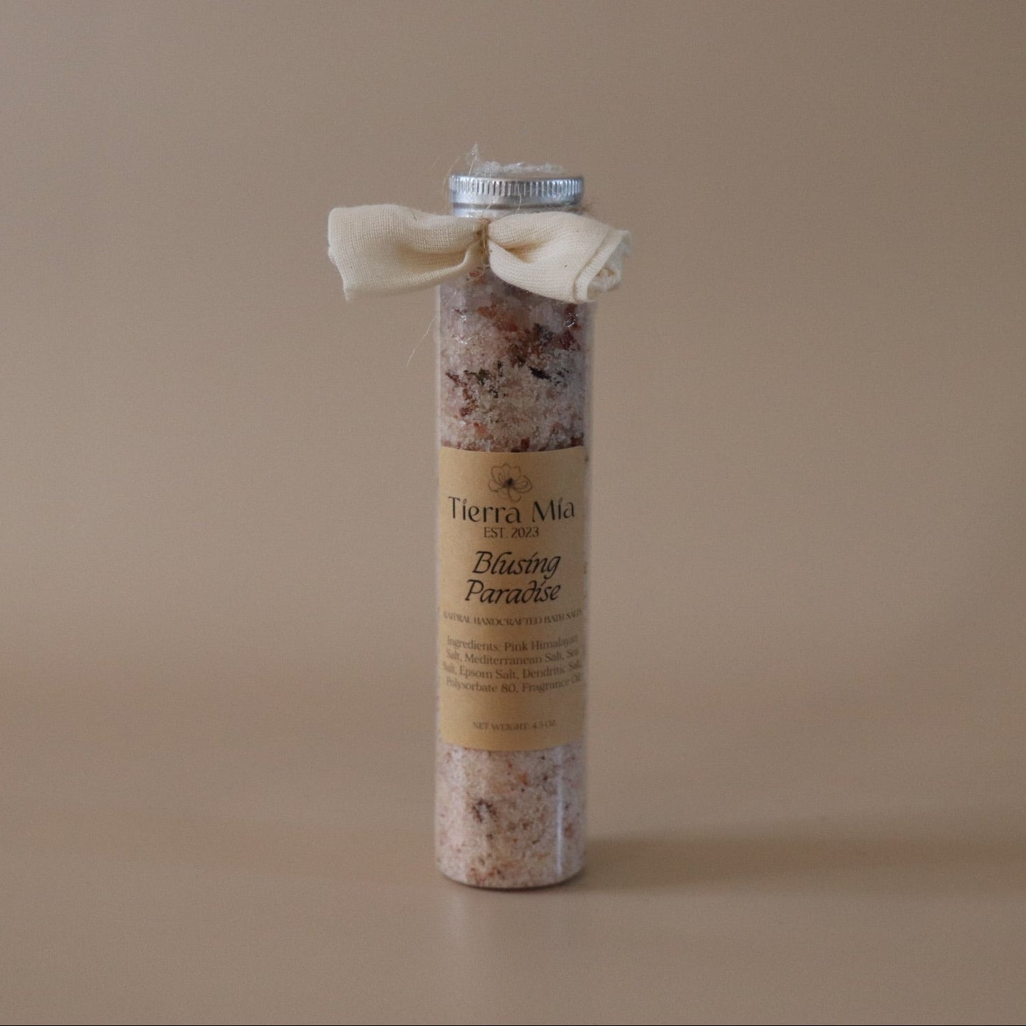 Cylindrical bath salt with a label on a beige background