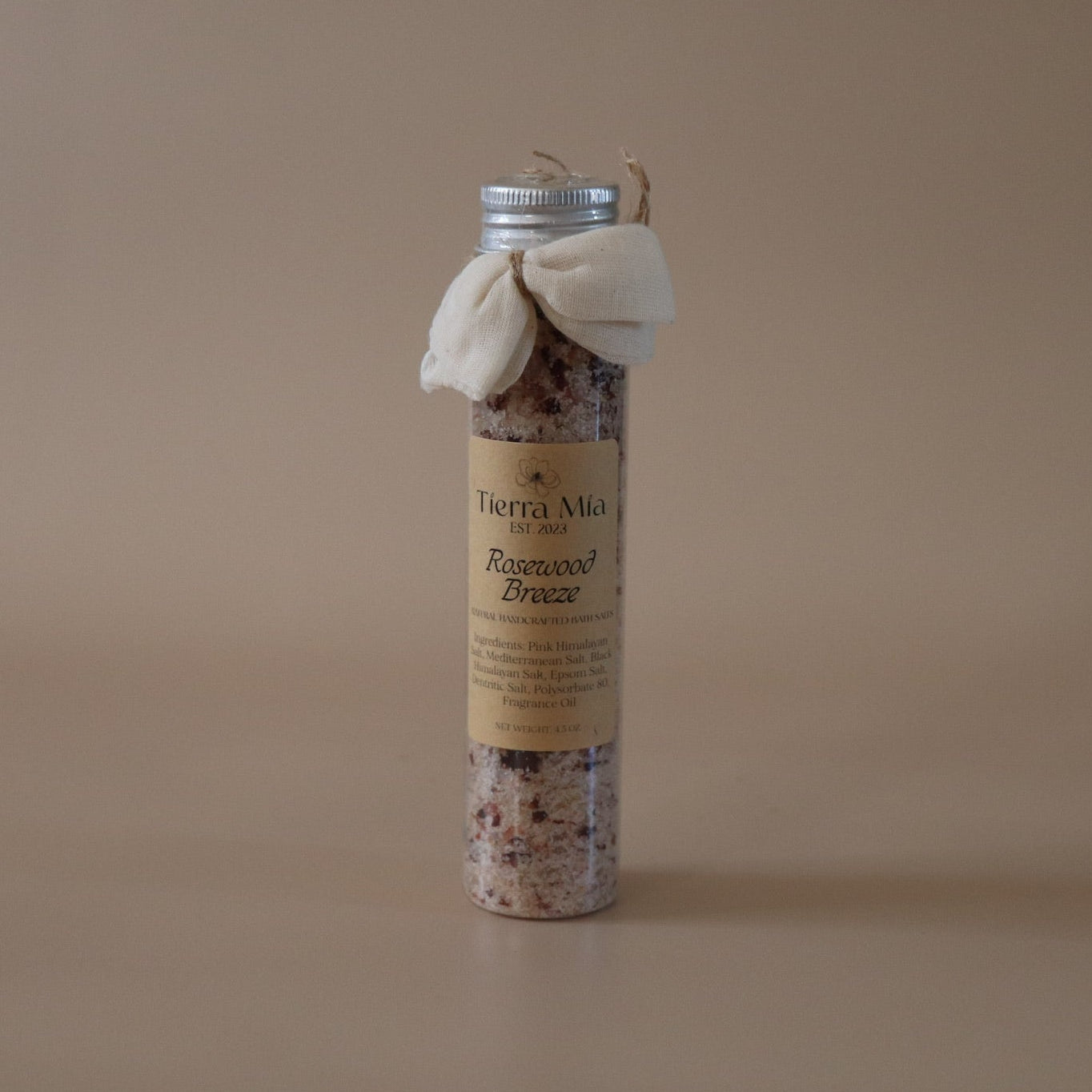 Small cylindrical product with a label on a beige background
