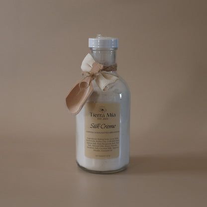 Bottle of Tierra Mia Silk Creme on a beige background